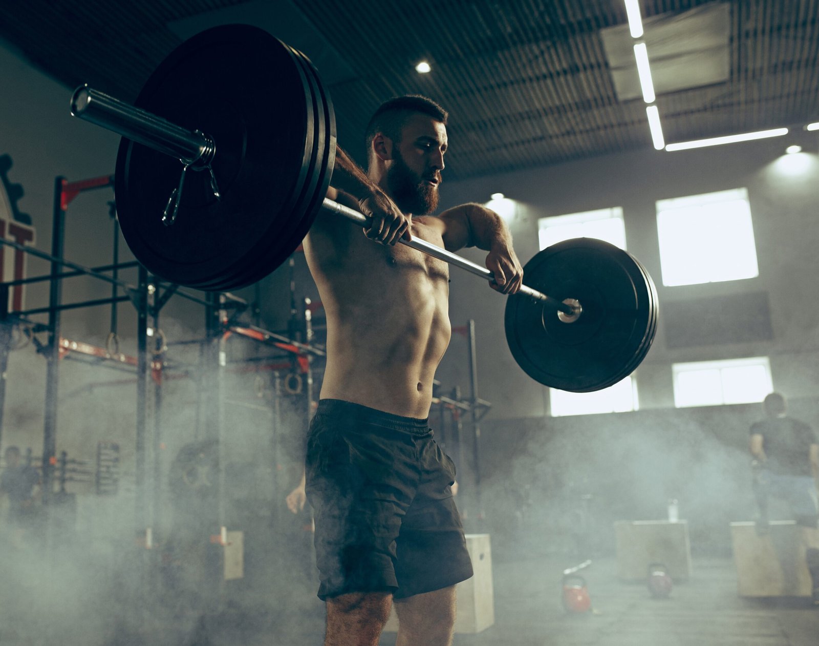 Fit young man lifting weight working out at a gym. Sport, fitness, weightlifting, bodybuilding, training, athlete, workout exercises concept